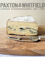 cote hill blue cheese on a wooden paxton and whitfield cheeseboard with cheese knife