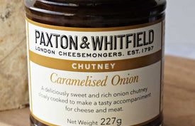 close up of paxton and whitfield caramelised onion chutney on wooden cheeseboard