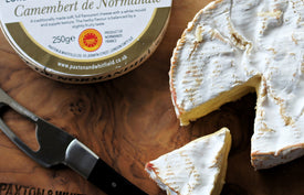 camebert de normandie on paxton and whitfield cheese board with cheese knife