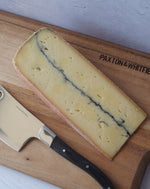 ashcombe cheese on a paxton and Whitfield wooden cheeseboard with cheese knife 