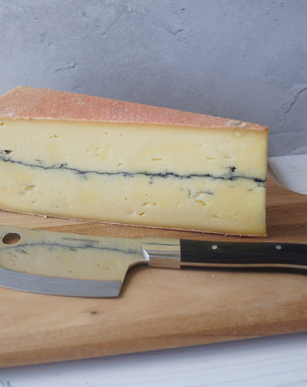 ashcombe cheese on a paxtona and whitfield wooden cheeseboard with cheese knife