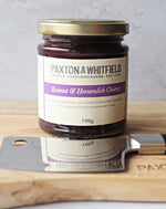 jar of beetroot and horseradish chutney with cheese knife on paxton and whitfield cheeseboard