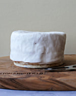 close up of whole brillat savarin affine on paxton and whitfield wooden cheeseboard