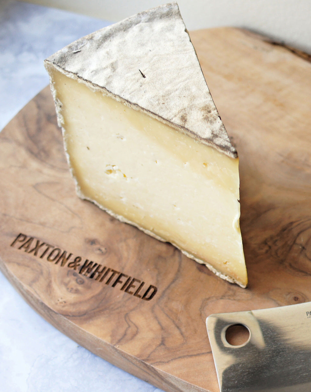 caerphilly gorwydd cheese on a wooden paxton and whitfield cheeseboard