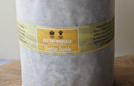 paxton and whitfield cheddar truckle cheese on paxton and whitfield wooden cheeseboard