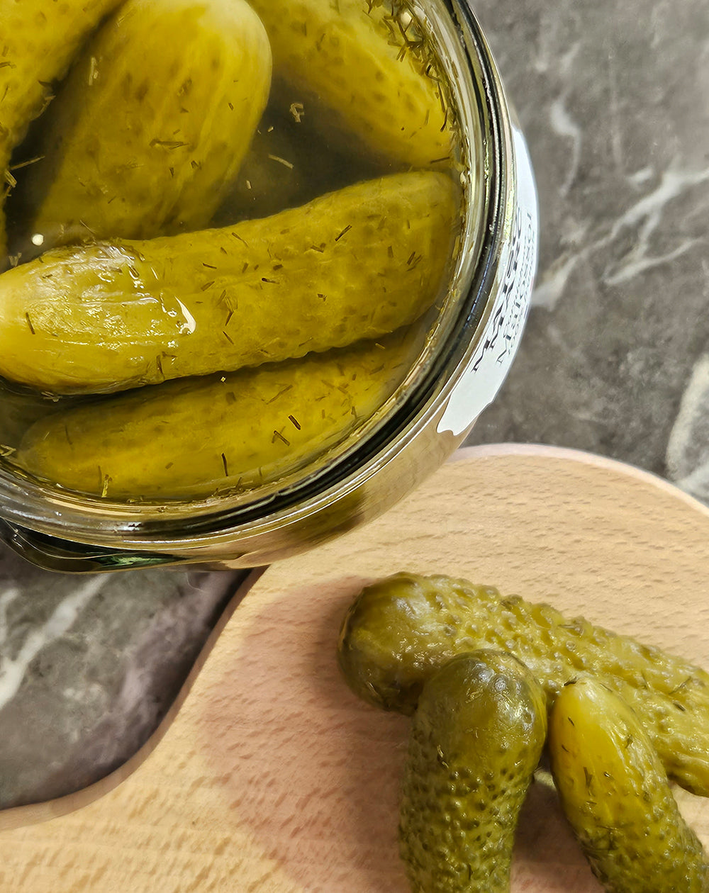 close up of open jar of cornichon malossol