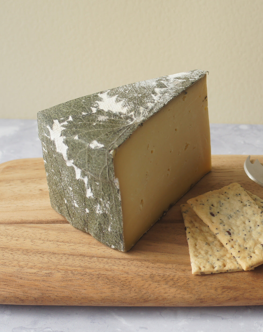 paxton and whitfield cornish yarg cheese on wooden cheeseboard