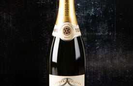 Bottle of Tissot-Maire sparkling wine on a dark background