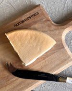 paxton and whitfield evenlode cows cheese on paxton and whitfield cheeseboard with cheese knife