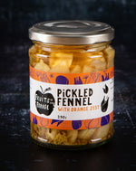 Jar of pickled fennel with orange zest on a dark background