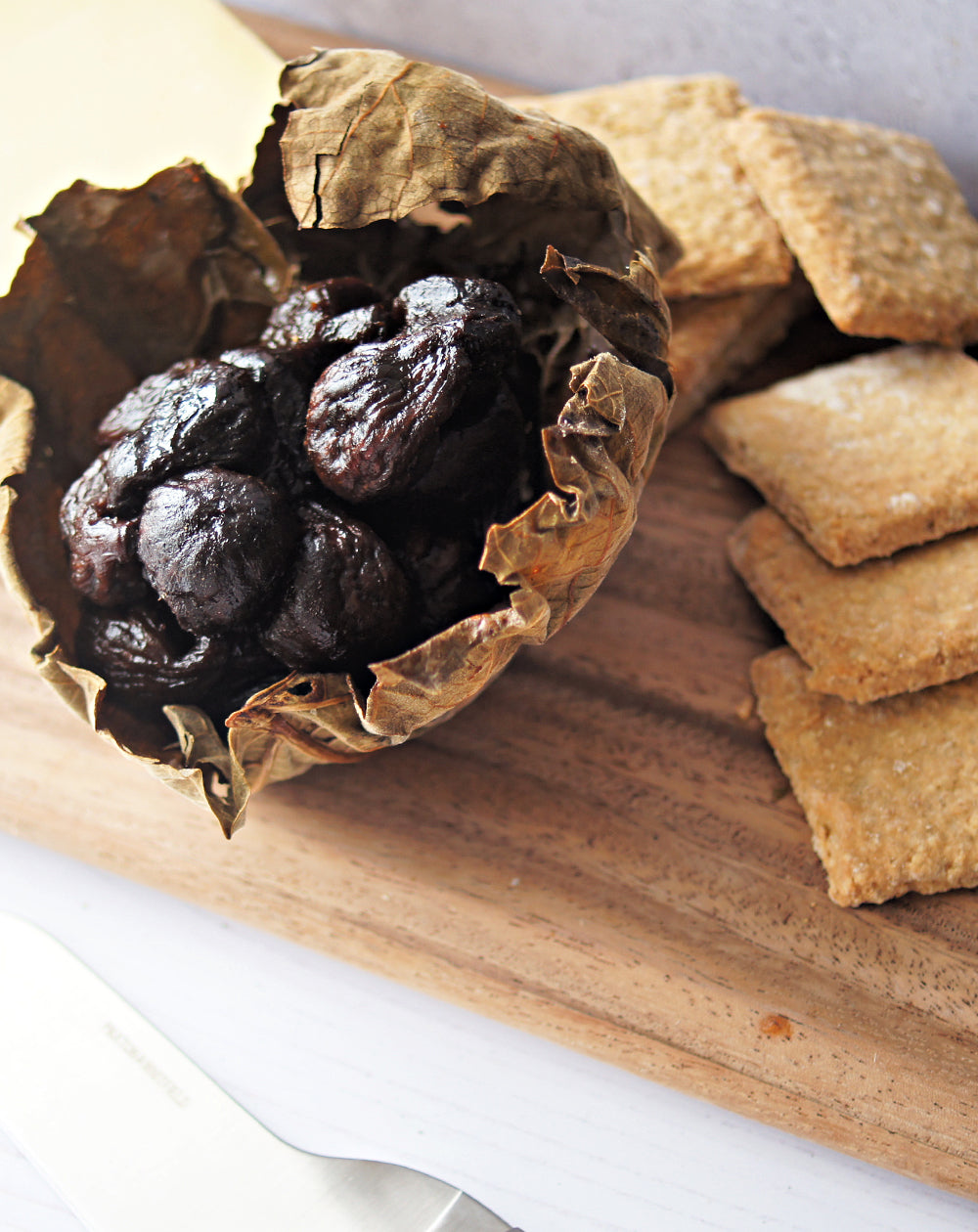 opened up paxton and whitfield fig ball showing figs inside on a wooden cheeseboard